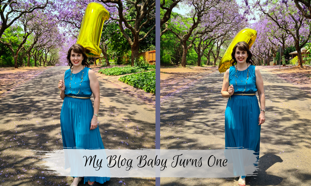 Lynette with number 1 balloon in front of Jacaranda trees